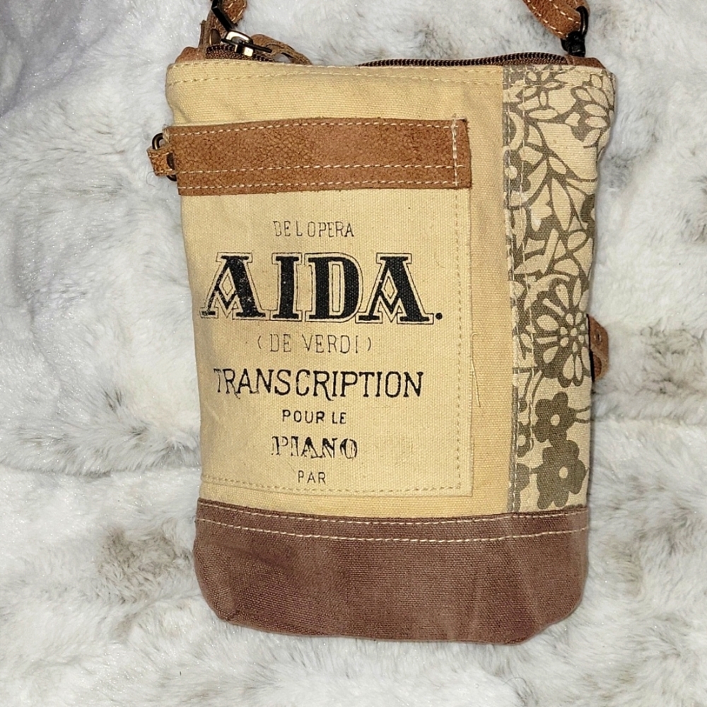 Vintage crossbody bag. Pocket in front and back zipper pocket.